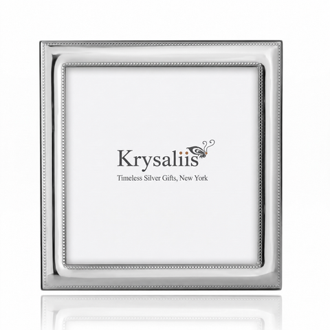 A square silver picture frame with a beaded inner border, shown empty against a white background with a faint reflection below. The brand name 'Krysaliis' is printed in the center of the insert.